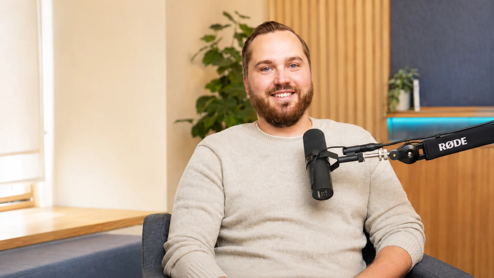 Ben Langner in a bright podcast studio
